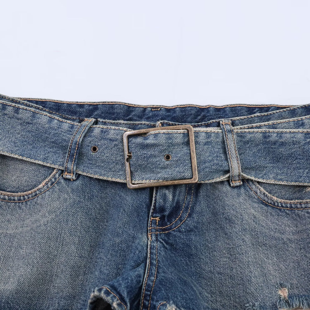 Spicy girl with belt and ripped denim shorts