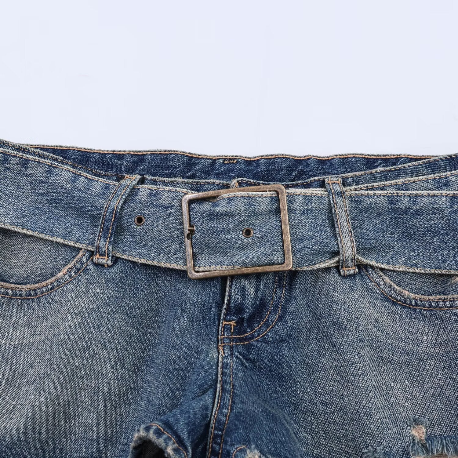 Spicy girl with belt and ripped denim shorts