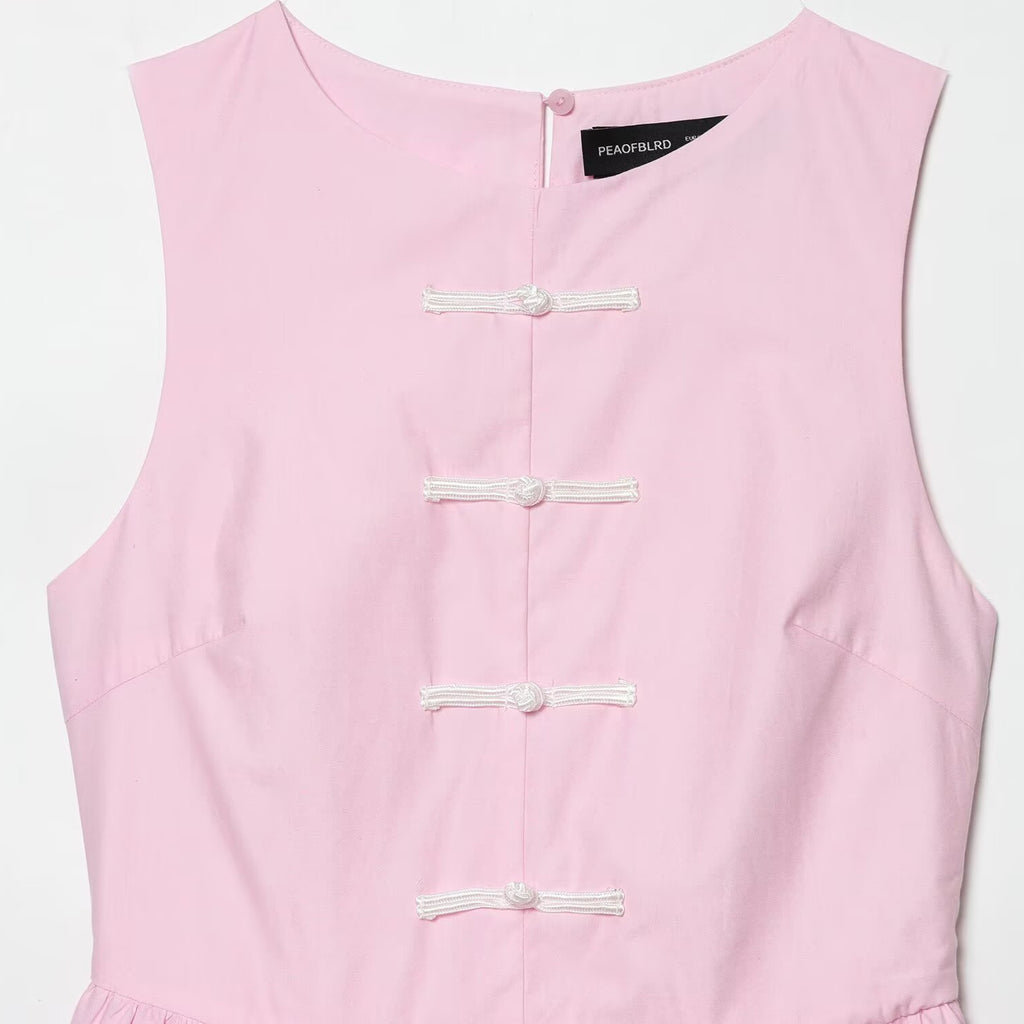 Sleeveless knot buckle embellished short skirt style hem top